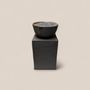Decorative objects - NATURAL SCENTED CANDLE IN A BLACK STONEWARE PIEDESTAL - OUD WOOD - CLAIRE POUJOULA