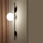 Wall lamps - LYMINGTON wall lamp with opalised globe and black/gold structure - LUXCAMBRA