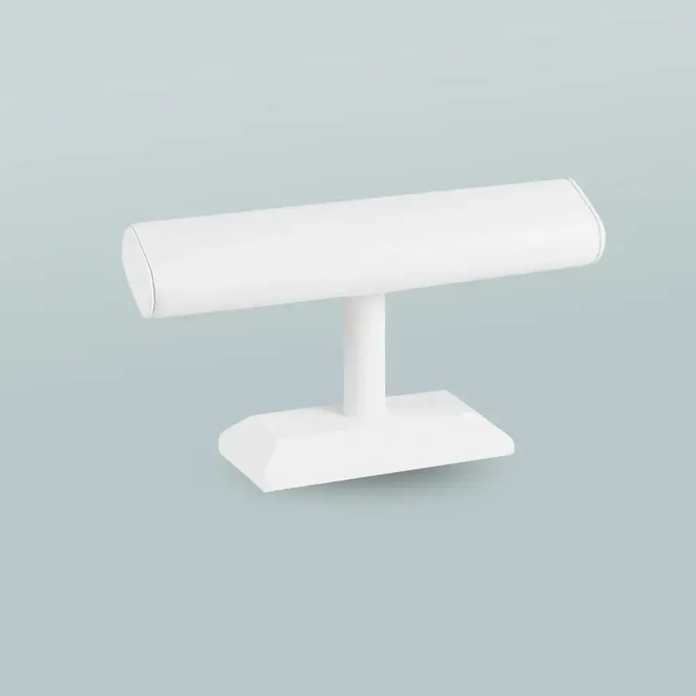 Gifts - Angled bracelet display stand on a smooth-looking white, upholstered base - LAVAL 1878